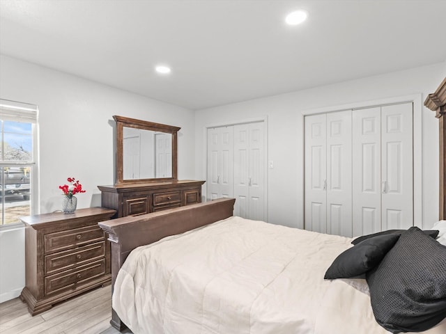 3939 Ermis St, Haltom City, TX 76111 - bedroom featuring two closets, light wood-type flooring, recessed lighting, and baseboards