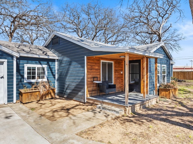3939 Ermis St, Haltom City, TX 76111 - rear view of property featuring fence, covered porch, and roof with shingles