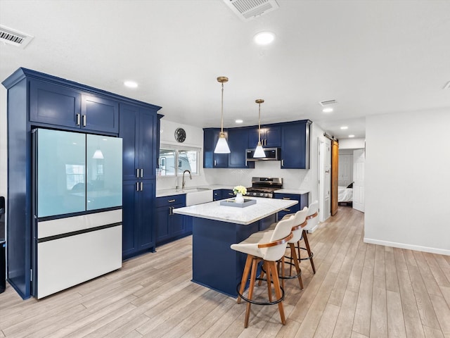3939 Ermis St, Haltom City, TX 76111 - kitchen with appliances with stainless steel finishes, blue cabinetry, a sink, light wood-style floors, and recessed lighting