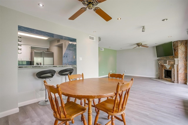 390 Driftwood Ct Unit 3B-1, Azle, TX 76020 - dining area with a ceiling fan, wood finished floors, baseboards, a fireplace, and recessed lighting