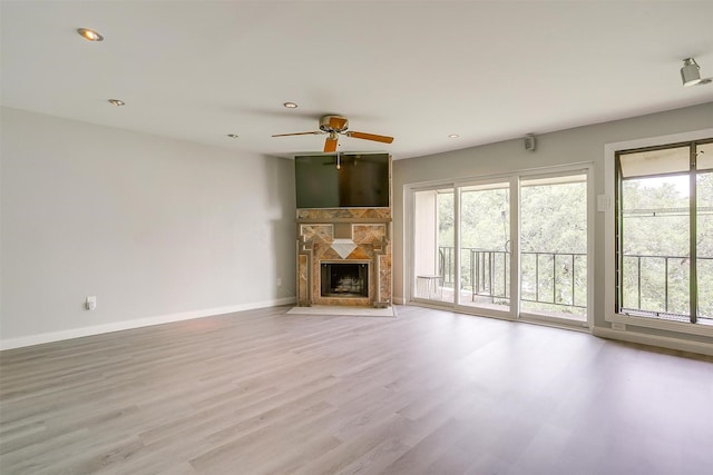 390 Driftwood Ct Unit 3B-1, Azle, TX 76020 - unfurnished living room featuring recessed lighting, baseboards, a fireplace with flush hearth, light wood-type flooring, and ceiling fan