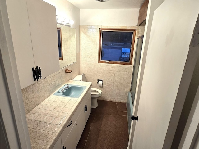 2804 Lynn Dell Dr, Tool, TX 75143 - full bathroom featuring toilet, tile walls, vanity, tile patterned flooring, and shower / bath combination with glass door