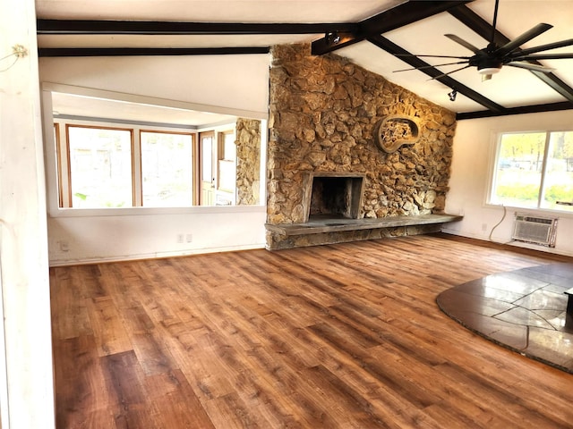 2804 Lynn Dell Dr, Tool, TX 75143 - unfurnished living room with ceiling fan, an AC wall unit, wood finished floors, a stone fireplace, and baseboards