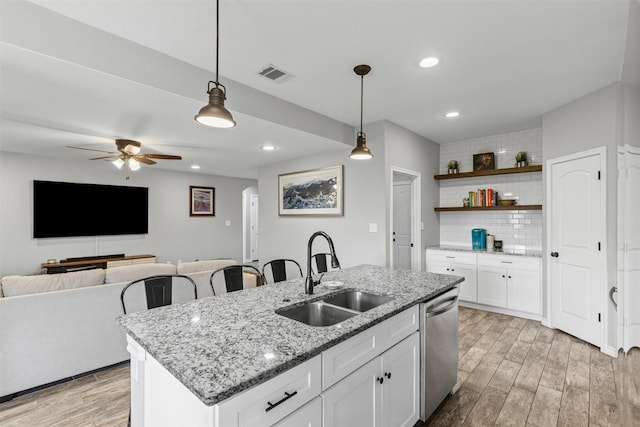 2104 Shane Ave, Fort Worth, TX 76134 - kitchen featuring a sink, dishwasher, light wood-type flooring, decorative backsplash, and ceiling fan
