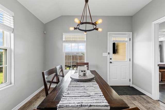 2104 Shane Ave, Fort Worth, TX 76134 - dining area with a chandelier, wood finished floors, plenty of natural light, baseboards, and lofted ceiling