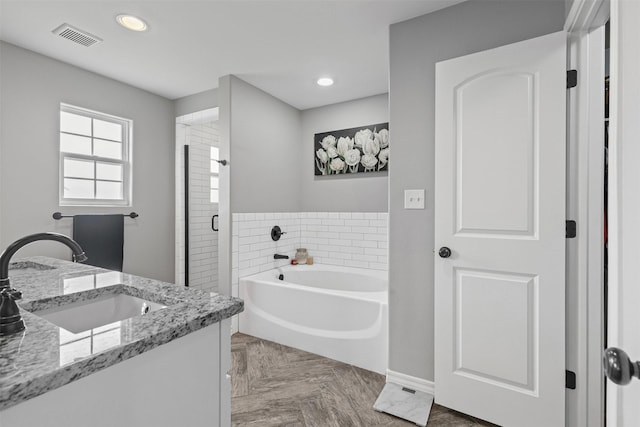2104 Shane Ave, Fort Worth, TX 76134 - bathroom featuring a garden tub, marble finish flooring, a stall shower, vanity, and recessed lighting