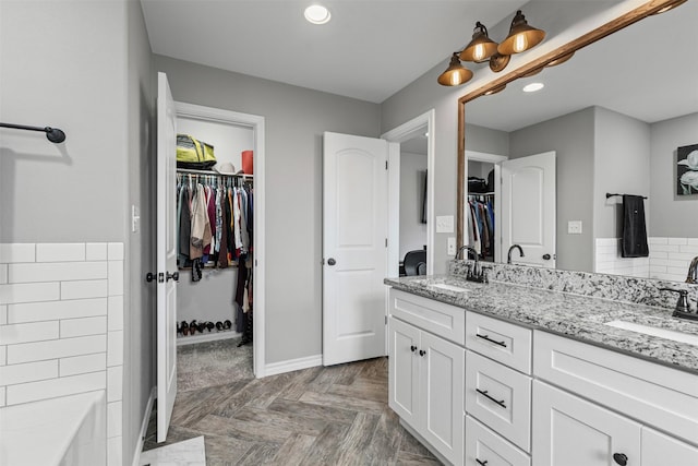 2104 Shane Ave, Fort Worth, TX 76134 - full bathroom featuring double vanity, baseboards, recessed lighting, and a walk in closet