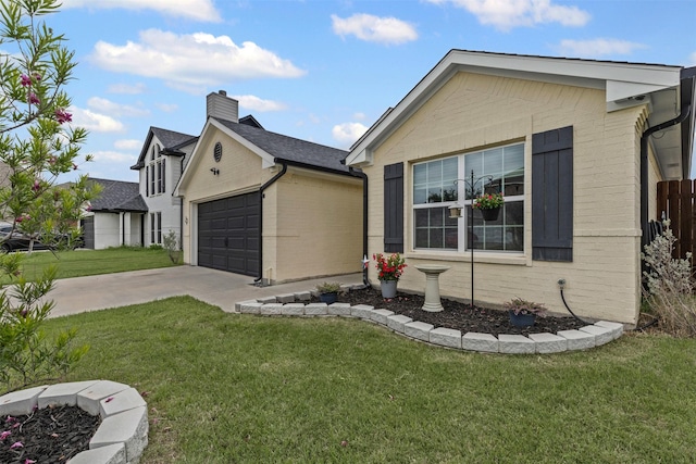 2104 Shane Ave, Fort Worth, TX 76134 - view of front of home with a front yard, an attached garage, driveway, a chimney, and brick siding