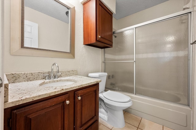 1204 Calico Ln Unit 720, Arlington, TX 76011 - full bathroom featuring vanity, enclosed tub / shower combo, tile patterned floors, and a textured ceiling