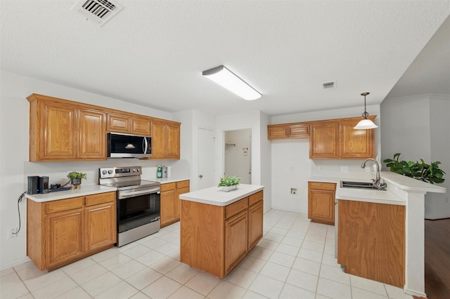 218 Whispering Dell Ln, Weatherford, TX 76085 - kitchen with stainless steel appliances, a sink, light countertops, brown cabinets, and a textured ceiling