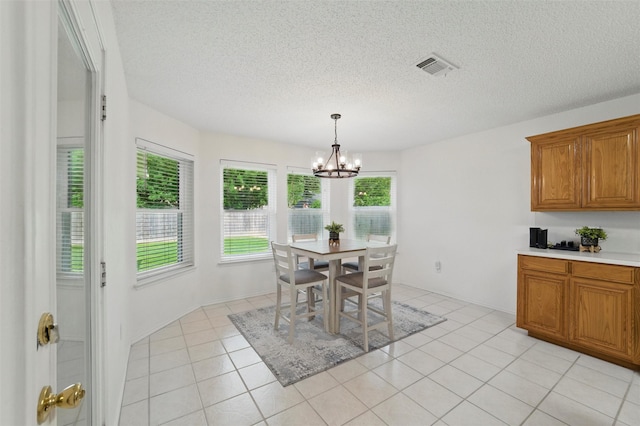 218 Whispering Dell Ln, Weatherford, TX 76085 - dining area with plenty of natural light, a chandelier, a textured ceiling, and light tile patterned floors