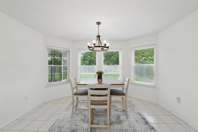 218 Whispering Dell Ln, Weatherford, TX 76085 - dining space with a chandelier, plenty of natural light, light tile patterned floors, and a textured ceiling