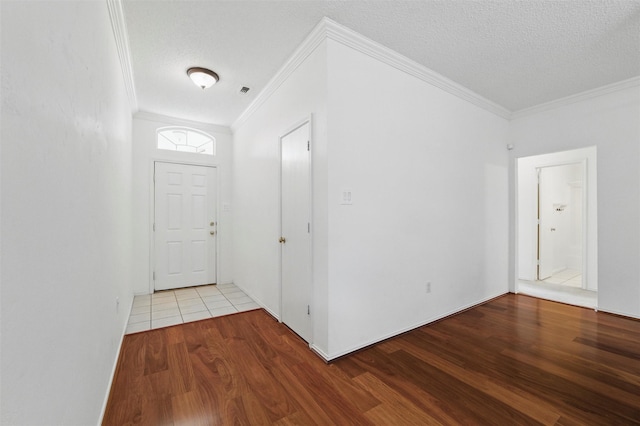 218 Whispering Dell Ln, Weatherford, TX 76085 - foyer with wood finished floors, ornamental molding, and a textured ceiling