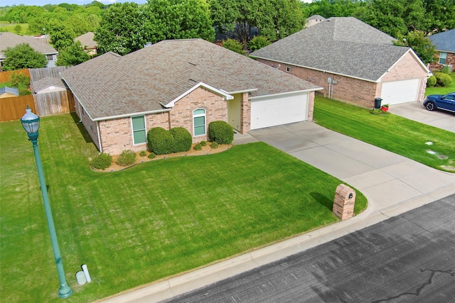 218 Whispering Dell Ln, Weatherford, TX 76085 - view of front facade featuring brick siding, a shingled roof, concrete driveway, and a garage