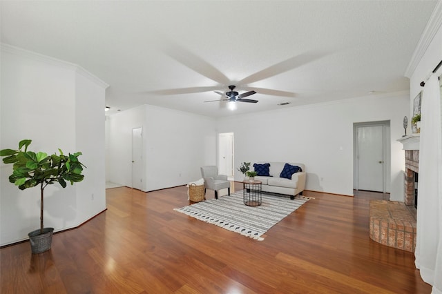 218 Whispering Dell Ln, Weatherford, TX 76085 - living area with ceiling fan, wood finished floors, a fireplace, and ornamental molding