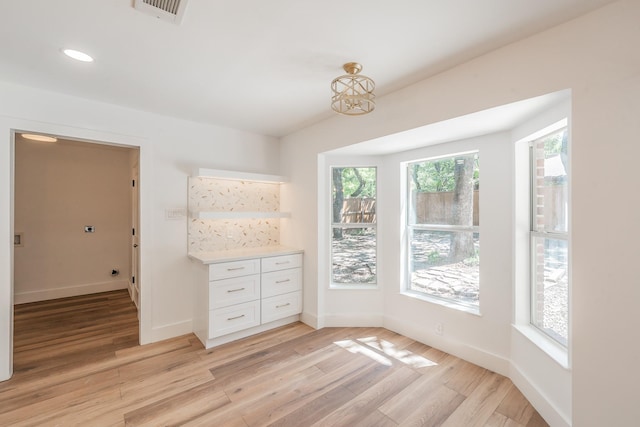 2815 Perkins Rd, Arlington, TX 76016 - unfurnished dining area featuring light wood-type flooring, baseboards, and recessed lighting