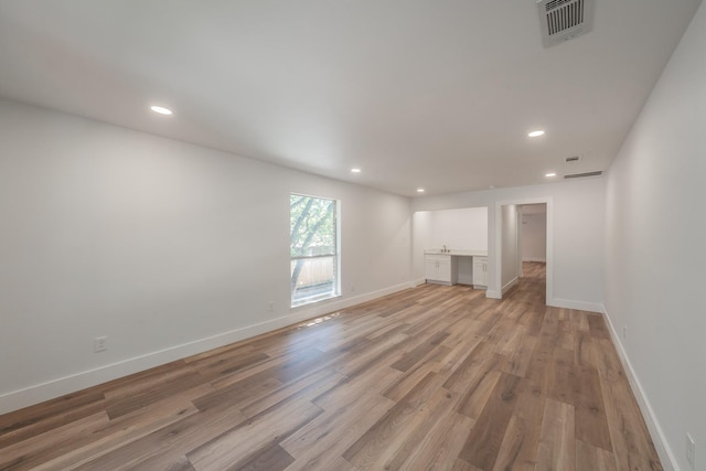 2815 Perkins Rd, Arlington, TX 76016 - unfurnished living room with light wood-type flooring, recessed lighting, and baseboards