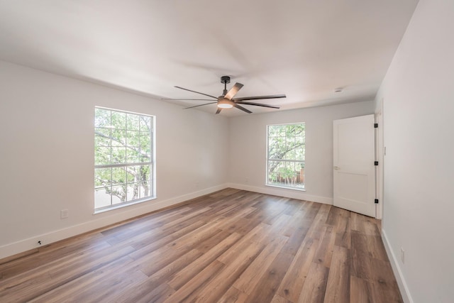 2815 Perkins Rd, Arlington, TX 76016 - empty room with wood finished floors, a ceiling fan, and baseboards