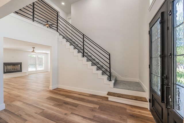 2815 Perkins Rd, Arlington, TX 76016 - foyer entrance featuring baseboards, wood finished floors, stairs, recessed lighting, and a towering ceiling