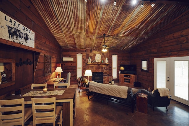 6305 Barrel Spring Rd, Nocona, TX 76255 - living area featuring lofted ceiling, a fireplace, french doors, ceiling fan, and wooden walls