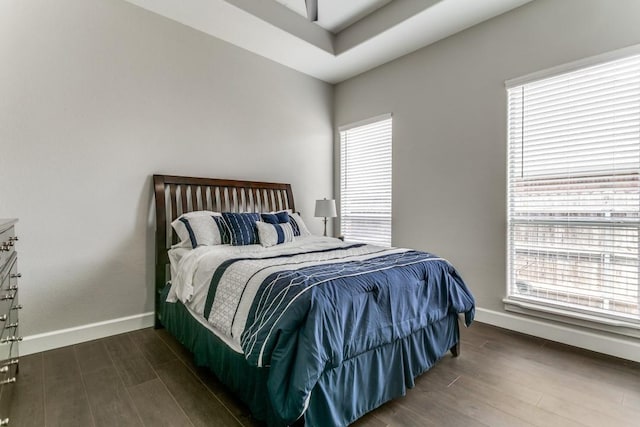 bedroom featuring wood finished floors and baseboards