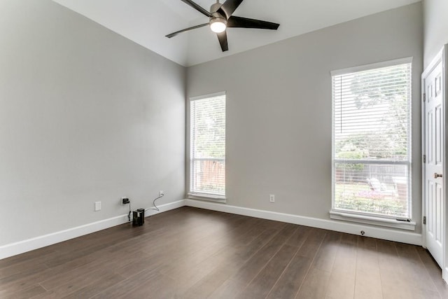unfurnished room with ceiling fan, dark wood-type flooring, and baseboards