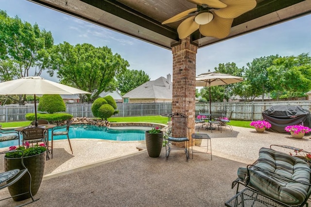 view of pool featuring outdoor dining space, a patio, ceiling fan, a fenced backyard, and area for grilling
