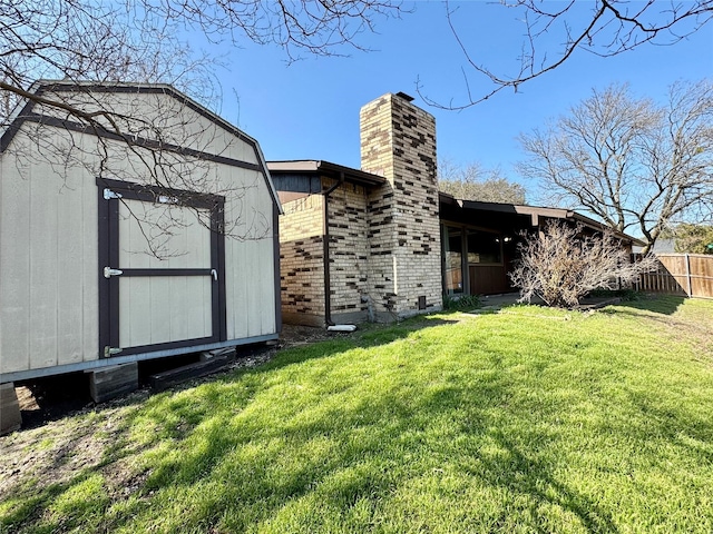 7302 Hardwood Trl, Dallas, TX 75249 - back of house featuring a chimney, an outdoor structure, a shed, and brick siding