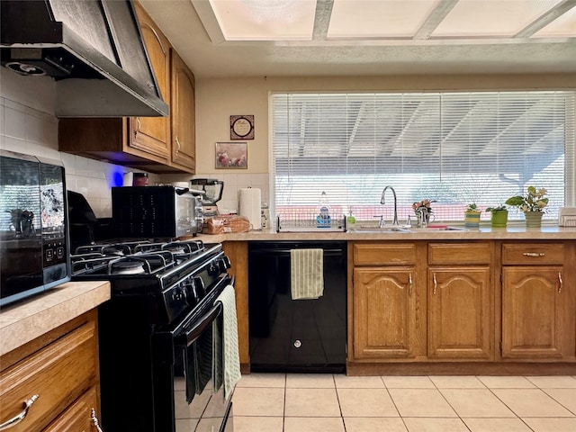 7302 Hardwood Trl, Dallas, TX 75249 - kitchen featuring black appliances, a sink, under cabinet range hood, brown cabinetry, and decorative backsplash