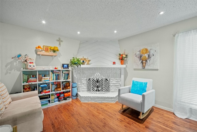 895 Dublin Dr Unit D, Richardson, TX 75080 - playroom with wood finished floors, a textured ceiling, and recessed lighting