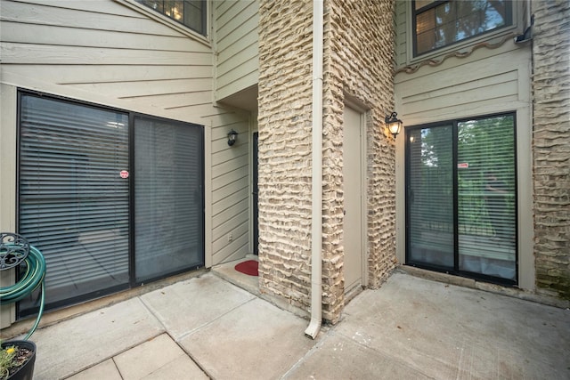 895 Dublin Dr Unit D, Richardson, TX 75080 - view of exterior entry featuring a patio area