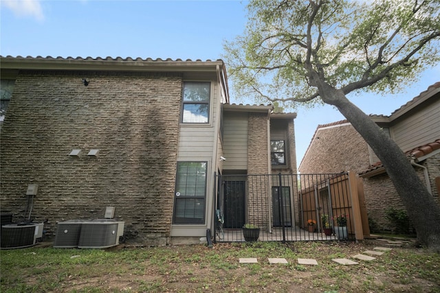 895 Dublin Dr Unit D, Richardson, TX 75080 - rear view of property featuring cooling unit and fence