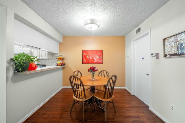 895 Dublin Dr Unit D, Richardson, TX 75080 - dining room with a textured ceiling, dark wood-style floors, and baseboards