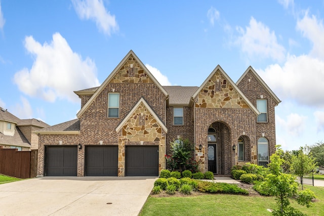 206 Stallion Ln, Hickory Creek, TX 75065 - tudor house featuring concrete driveway, brick siding, stone siding, and roof with shingles