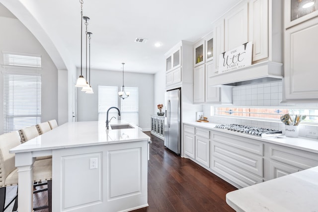 206 Stallion Ln, Hickory Creek, TX 75065 - kitchen featuring stainless steel refrigerator with ice dispenser, gas cooktop, a sink, arched walkways, and tasteful backsplash