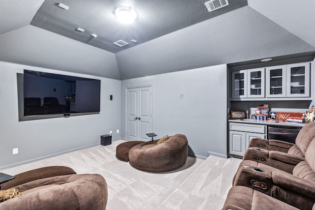 206 Stallion Ln, Hickory Creek, TX 75065 - home theater room with carpet floors, lofted ceiling, baseboards, a textured ceiling, and a dry bar