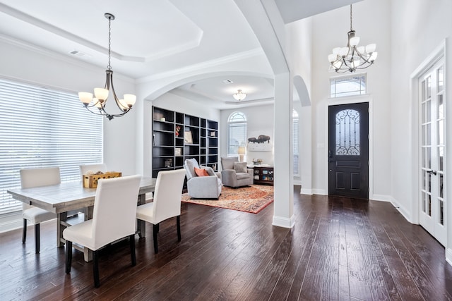 206 Stallion Ln, Hickory Creek, TX 75065 - dining room with a chandelier, arched walkways, dark wood-style floors, and a tray ceiling