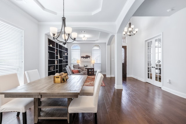 206 Stallion Ln, Hickory Creek, TX 75065 - dining room featuring a chandelier, a raised ceiling, and arched walkways