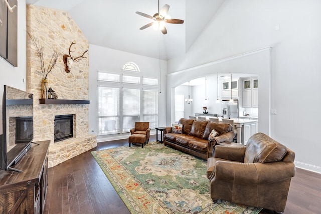 206 Stallion Ln, Hickory Creek, TX 75065 - living room featuring ceiling fan, a fireplace, high vaulted ceiling, dark wood finished floors, and arched walkways