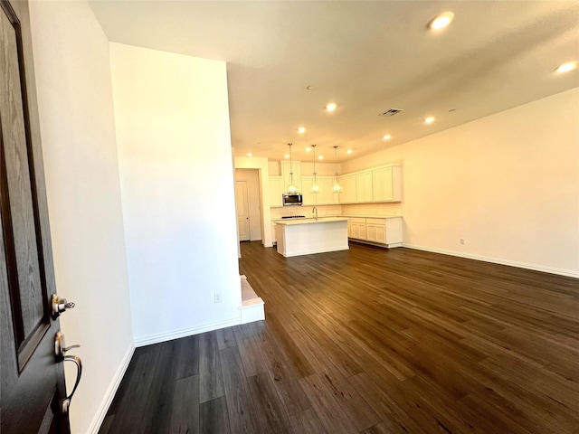 2933 Tenor Way, Sachse, TX 75048 - unfurnished living room with dark wood finished floors, recessed lighting, baseboards, and a sink