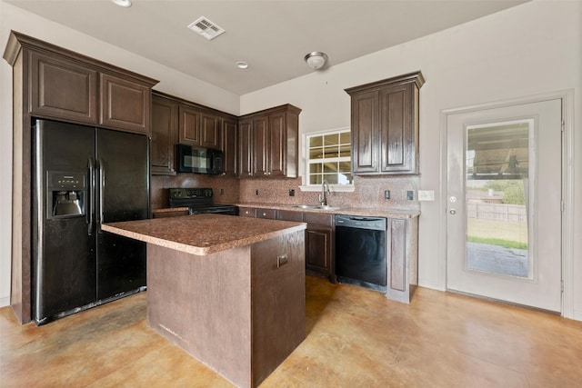300 Morris St, Riesel, TX 76682 - kitchen with black appliances, a sink, dark brown cabinetry, tasteful backsplash, and a center island