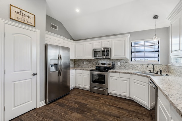 160 Grays Creek Cir, Alma, TX 75119 - kitchen with appliances with stainless steel finishes, a sink, vaulted ceiling, white cabinetry, and recessed lighting