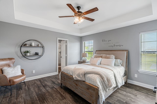 160 Grays Creek Cir, Alma, TX 75119 - bedroom featuring a raised ceiling, baseboards, and wood finished floors