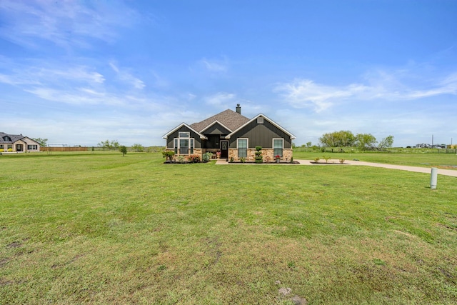 160 Grays Creek Cir, Alma, TX 75119 - view of front of house featuring a chimney, a front lawn, board and batten siding, and stone siding