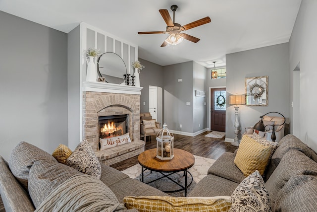 160 Grays Creek Cir, Alma, TX 75119 - living area with wood finished floors, ceiling fan, baseboards, and a brick fireplace