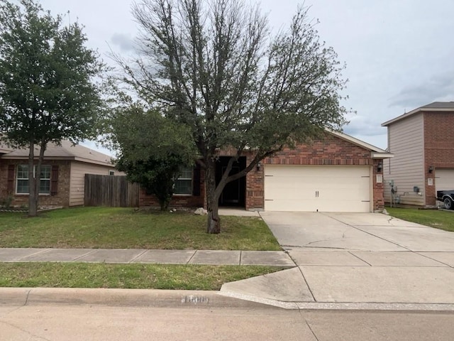 10009 Iron Ridge Dr, Fort Worth, TX 76140 - view of property hidden behind natural elements with a garage, brick siding, and concrete driveway