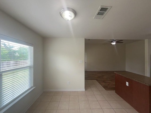 10009 Iron Ridge Dr, Fort Worth, TX 76140 - unfurnished room featuring light tile patterned floors, a ceiling fan, and baseboards