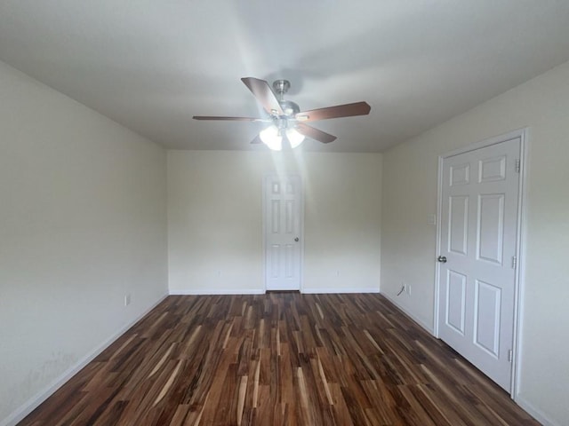 10009 Iron Ridge Dr, Fort Worth, TX 76140 - empty room with dark wood-style floors, a ceiling fan, and baseboards