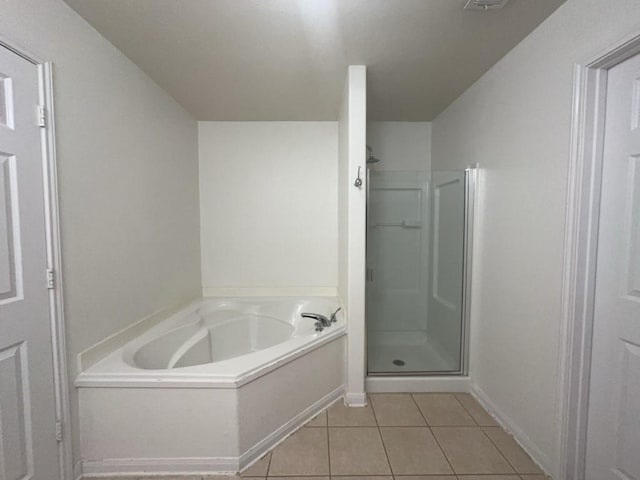 10009 Iron Ridge Dr, Fort Worth, TX 76140 - bathroom featuring tile patterned floors, a shower stall, a garden tub, and baseboards