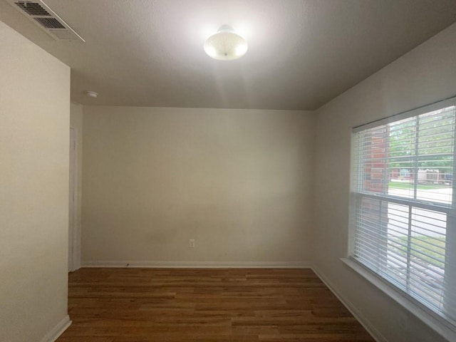 10009 Iron Ridge Dr, Fort Worth, TX 76140 - spare room with wood finished floors, healthy amount of natural light, and baseboards